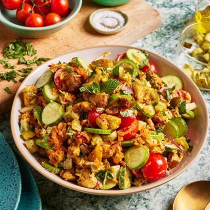 Crispy cumin Rice salad with chicken shawarma, cucumbers, pickled onions, tomatoes, parsley and a tahini dressing