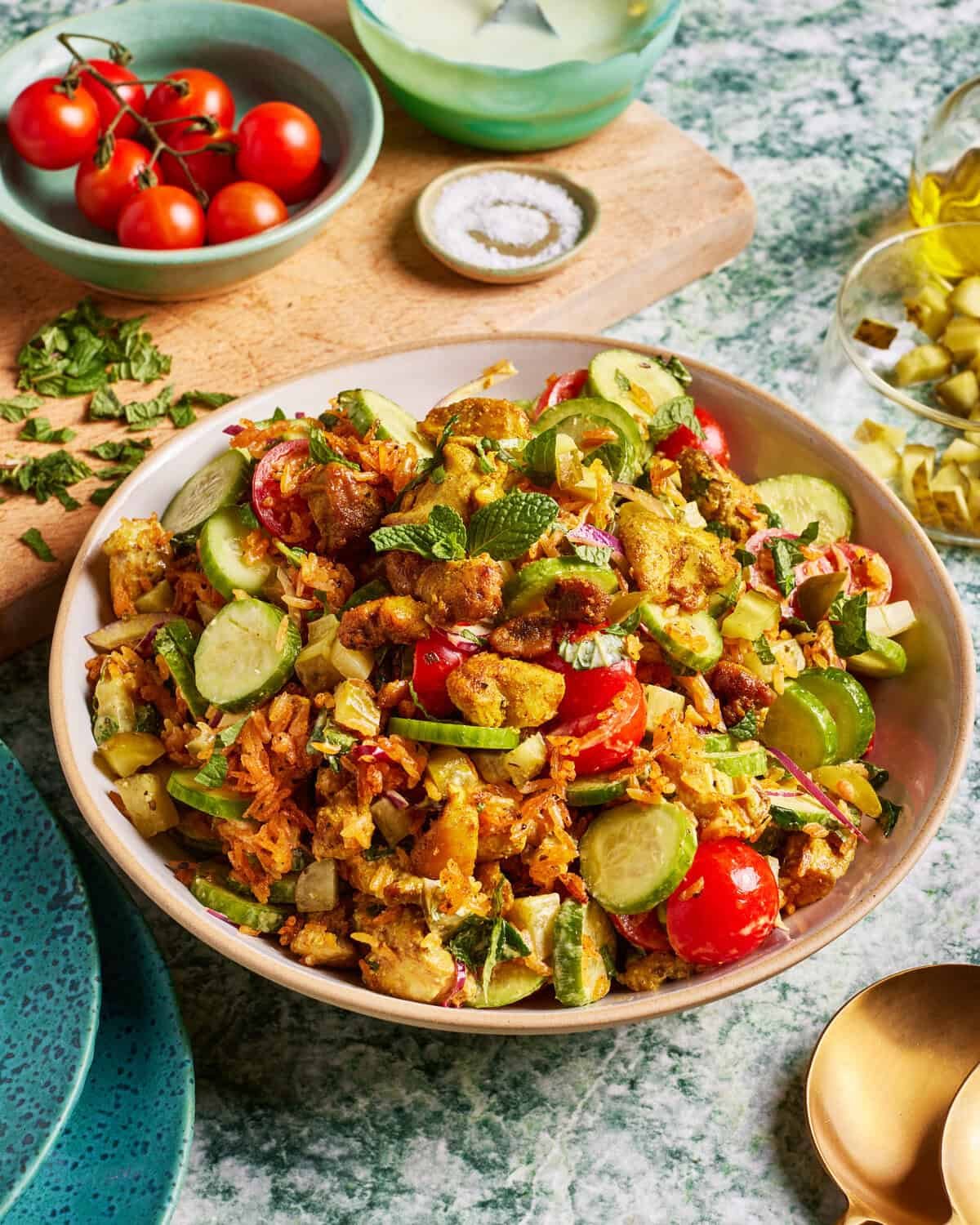 Crispy cumin Rice salad with chicken shawarma, cucumbers, pickled onions, tomatoes, parsley and a tahini dressing